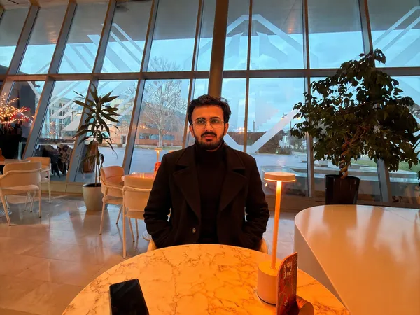 Ammar Haq seated in a café